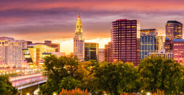Pictured: A cityscape of downtown Hartford during a sunset.