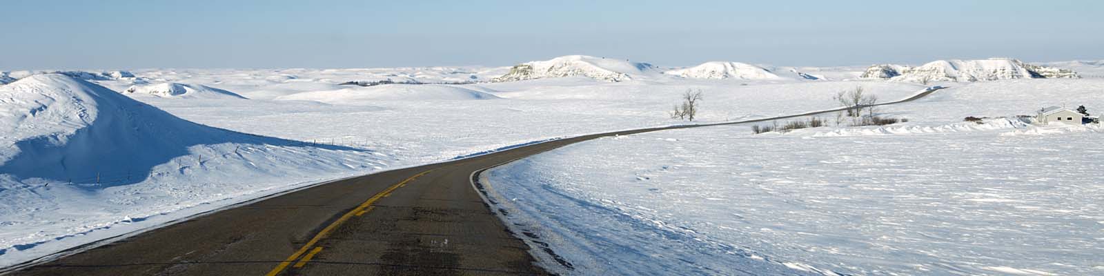 This is an image of a road surrounded by snow in Bismark North Dakota where ASTA-USA provides professional translation services.