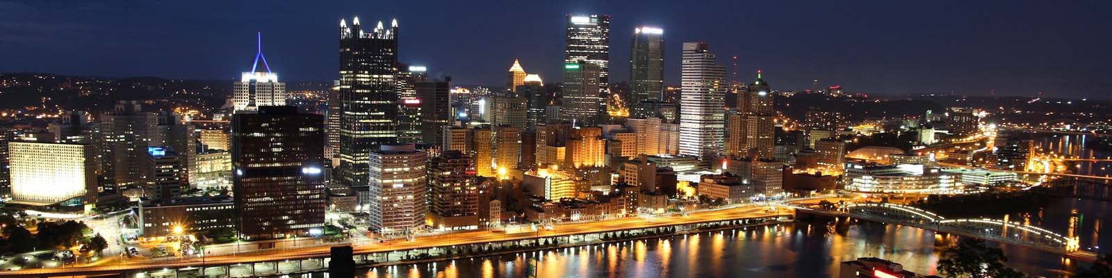 This is a skyline of downtown Pittsburgh at night. ASTA-USA offers professional translation services here.