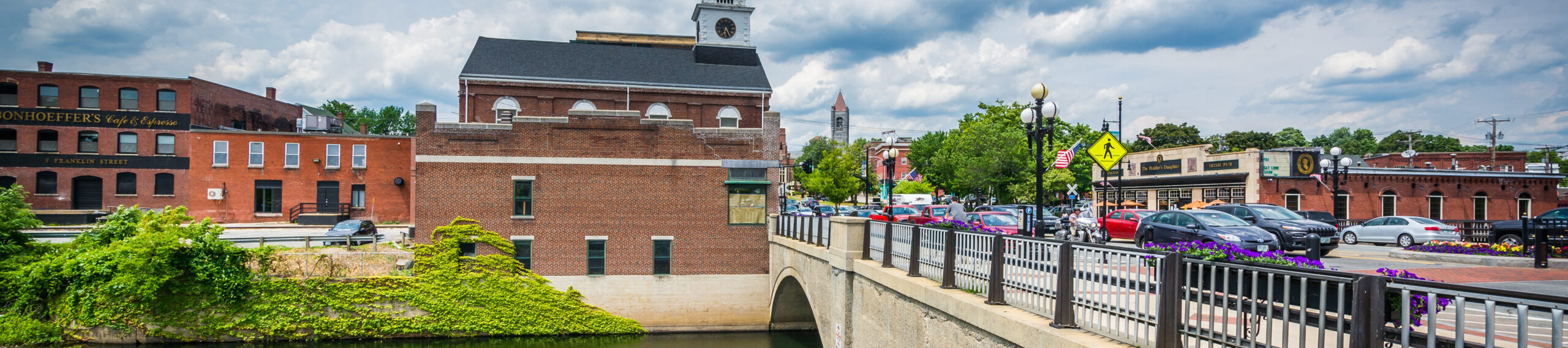 This is an image of a bridge and dowtown Nashua. ASTA-USA provides professional translation services in this city.